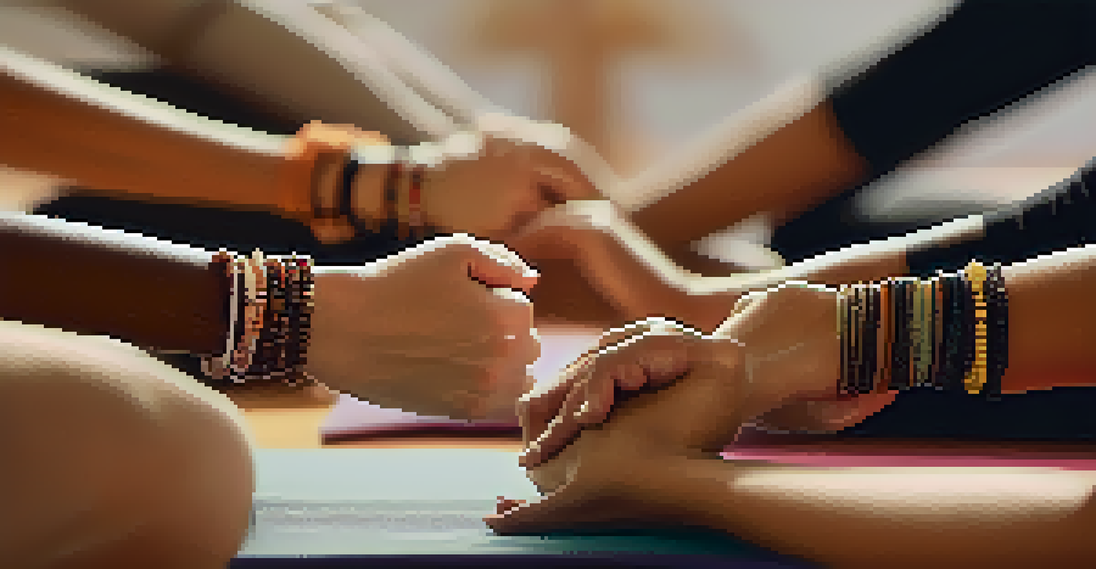 Close-up of a person's hands in a mudra gesture during a yoga class with blurred figures in the background.