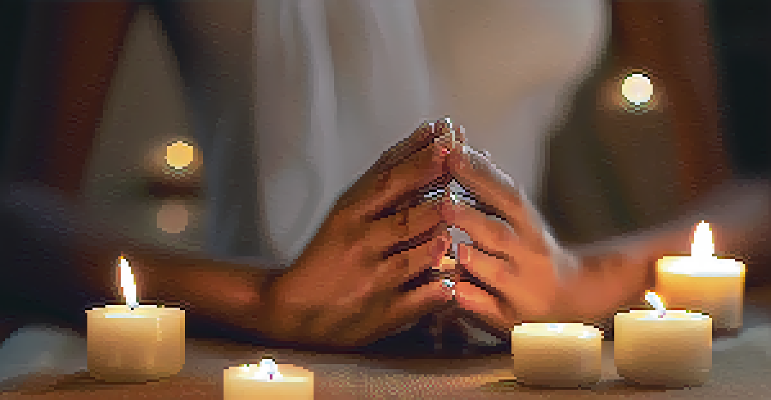 Close-up of hands in a prayer pose on a yoga mat, surrounded by candles and essential oils, creating a calming atmosphere.