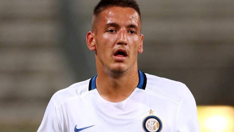 Beyaz Inter forması giyen bir futbolcu, ağzı açık şekilde yakın planda kameraya bakıyor.