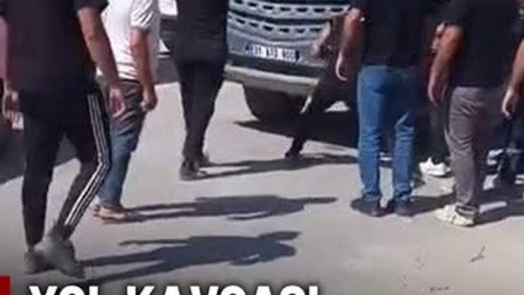 Bir grup insan, bir beton mikserinin etrafında toplanmış, bazıları mikseri yumrukluyor.