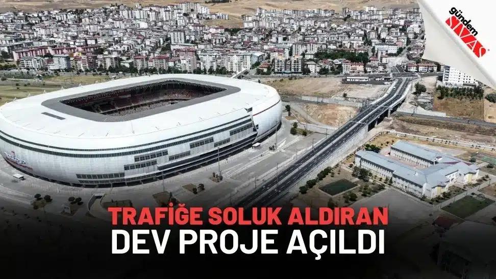 Bir stadyum ve çevresindeki alanın havadan görünümü, yeni bir ulaşım projesinin açılışıyla ilgili.