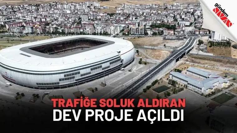 Bir stadyum ve çevresindeki alanın havadan görünümü, yeni bir ulaşım projesinin açılışıyla ilgili.