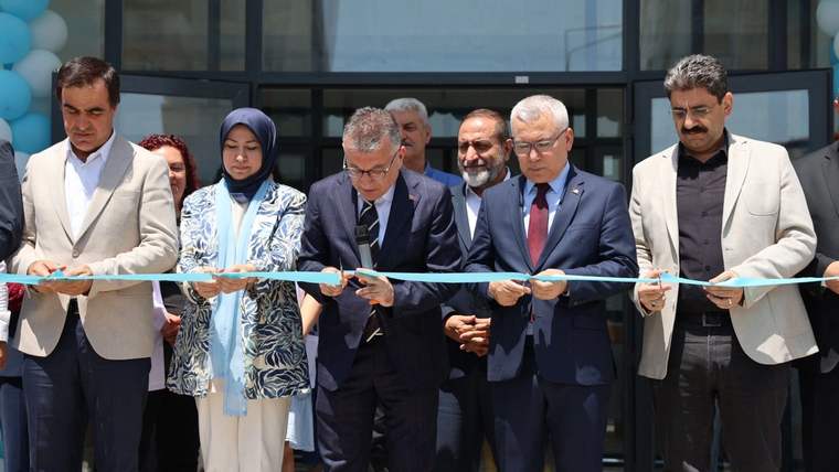 Kurdele kesen kalabalık, yeni açılan aile sağlığı merkezinin önünde duruyor.