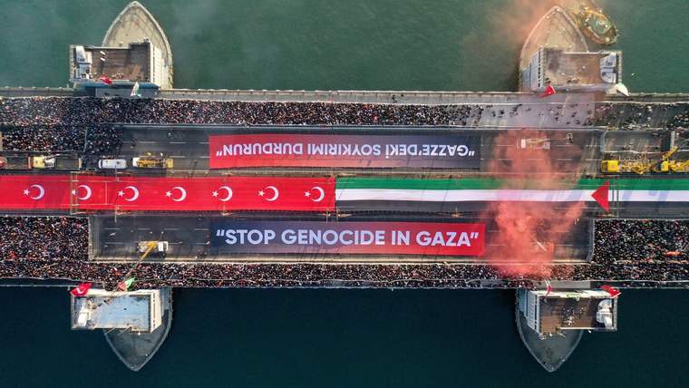 Havadan görülen köprüde kalabalık, Türk bayrakları ve “STOP GENOCIDE IN GAZA” yazılı pankartlar bulunuyor.
