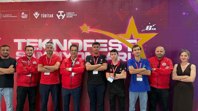 Teknofest'te yer alan Sivas Cumhuriyet Üniversitesi ekibi, arka planda etkinlik logosu ile birlikte poz veriyor.