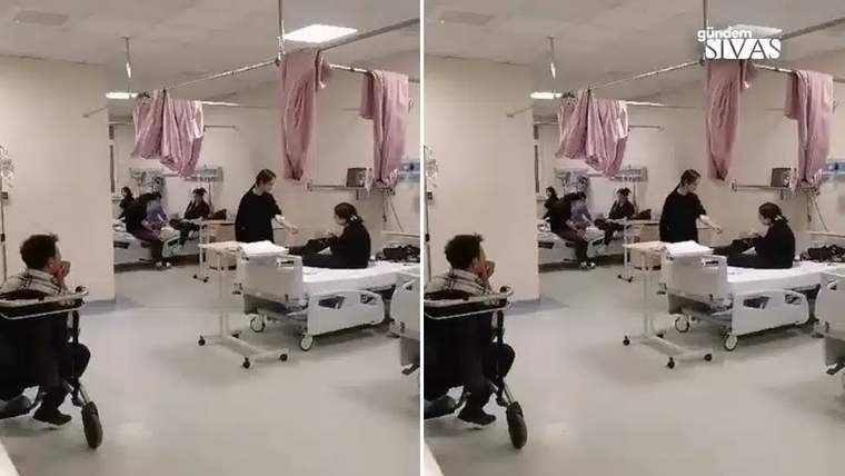 Hastane servisinde yataklarda oturan kişiler ve aralarında duran sağlık çalışanları görülüyor.