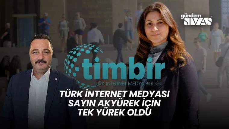 Bir adam ve bir kadın, arka planda bir bina önünde duruyor. Üzerinde 'timbir' yazılı bir logo görünüyor.