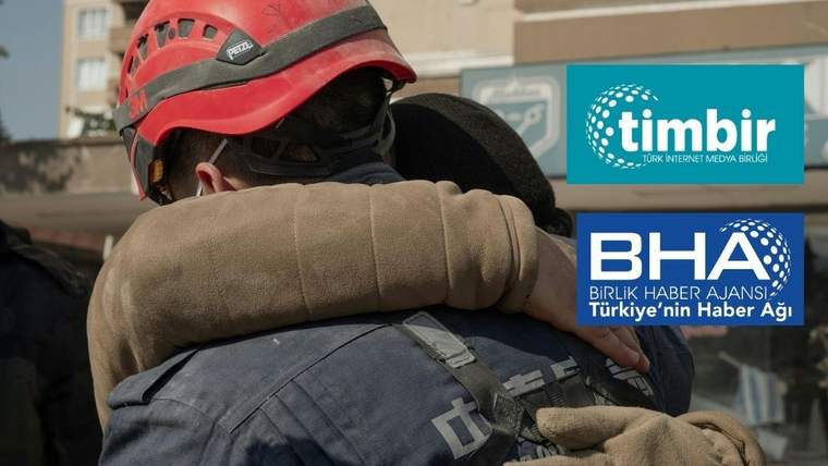 Kırmızı kasklı itfaiyeci, yüzü görünmeyen bir kişiye sarılırken sağda TİMBİR ve BHA logoları yer alıyor.