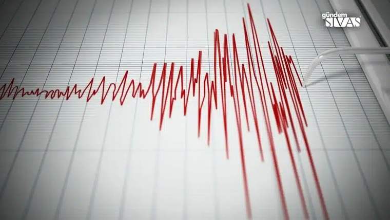 Sismograf üzerinde deprem dalgalarını gösteren kırmızı çizgiler.