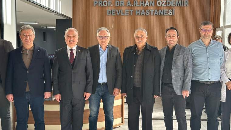 Giresun Prof. Dr. İlhan Özdemir Devlet Hastanesi yazısı önünde yan yana duran altı kişi