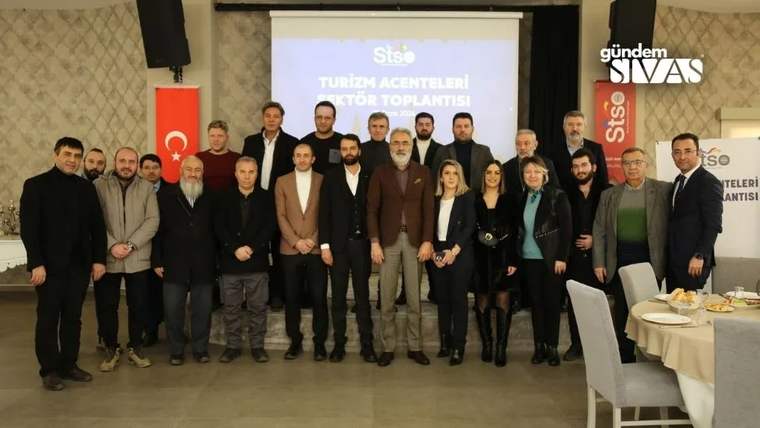 Bir grup insan, turizm acenteleri sektör toplantısında bir araya gelmiş.