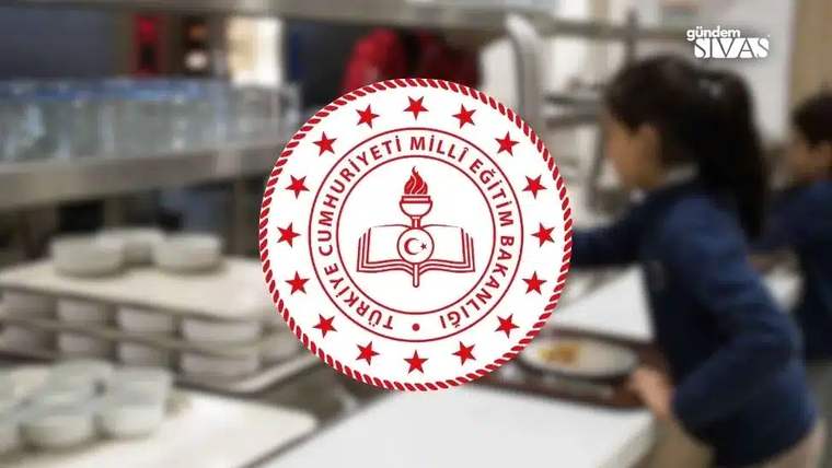 Türkiye Cumhuriyeti Millî Eğitim Bakanlığı amblemi, bulanık bir yemekhane ve servis tezgâhının önünde duruyor.