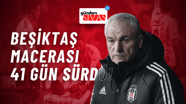 Bir kişi, spor takımının oyuncularının arka planda olduğu bir ortamda, ceket giymiş olarak kameraya bakıyor.