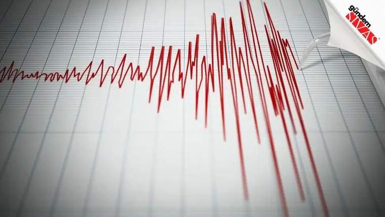 Sismograf üzerinde deprem dalgalarını gösteren kırmızı çizgiler.