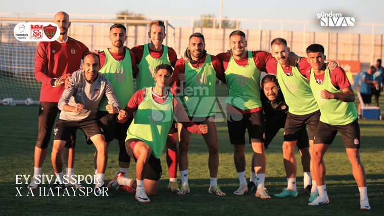 Sivasspor futbol takımı, antrenman sırasında gülümseyen oyuncularla birlikte poz veriyor.