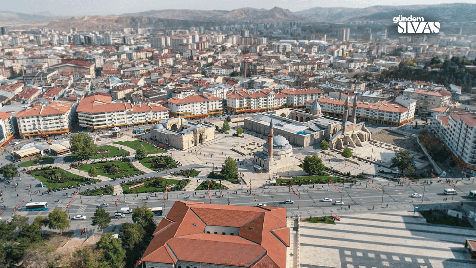 Sivas'ın merkezinde yer alan tarihi bir cami ve çevresindeki binalar, yeşil alanlar ve yollar görünmekte.