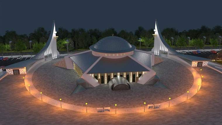 Modern bir cami binası, çevresinde aydınlatmalar ve ağaçlar ile birlikte görünmekte.
