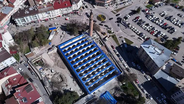 Sivas Ulu Cami'nin restorasyon çalışmaları sırasında çekilmiş havadan bir görüntü, mavi branda ile kaplanmış alan ve çevresindeki park alanları görünüyor.