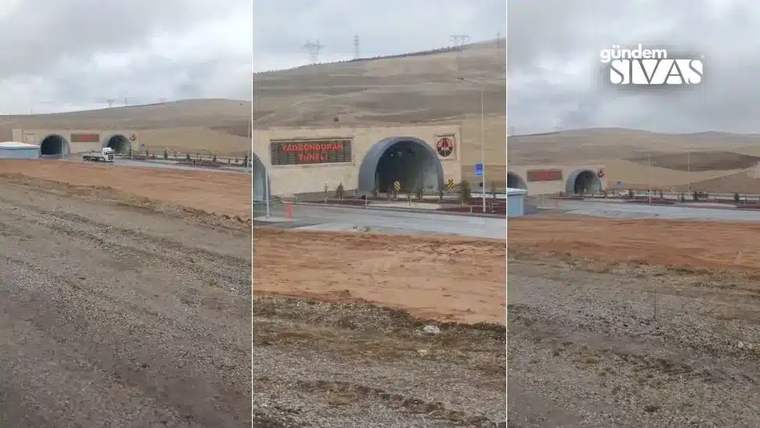 Bozkır bir arazide, girişinde kırmızı yazılı tabela bulunan iki tüp tünel ağzı görülüyor.