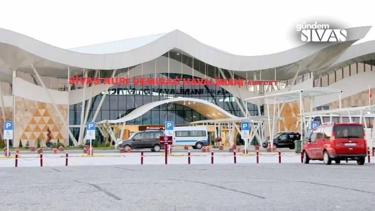 Sivas Nuri Demirağ Havalimanı terminali önünde park halindeki otobüsler ve araçlar görülüyor.