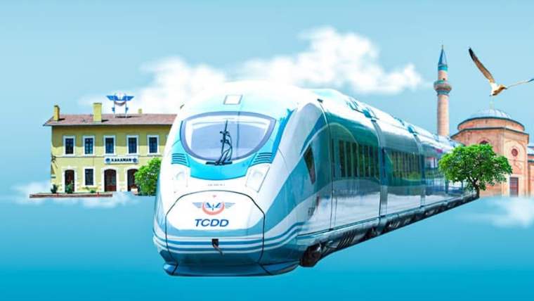 Mavi ve beyaz renkte bir yüksek hızlı tren, arka planda tarihi bir bina ve ağaçlar ile birlikte görünüyor.