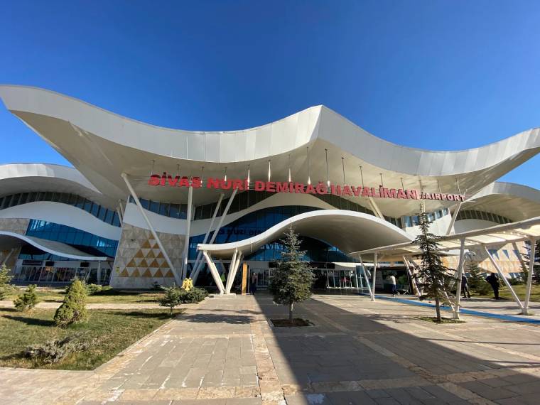 Sivas Nuri Demirağ Havalimanı tabelasının bulunduğu modern terminal binasının dış cephesi ve giriş yolu.
