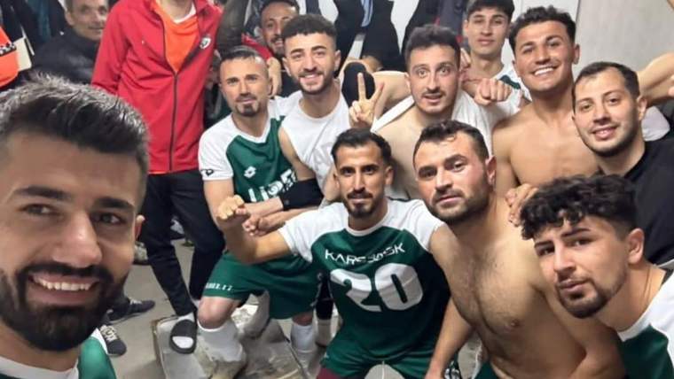 Kars 36 Spor futbol takımı, soyunma odasında galibiyet sonrası sevinçle poz veriyor.