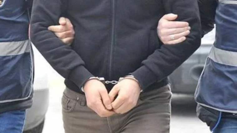Kelepçeli bir kişinin, başka bir kişi tarafından kolundan tutulduğu an.