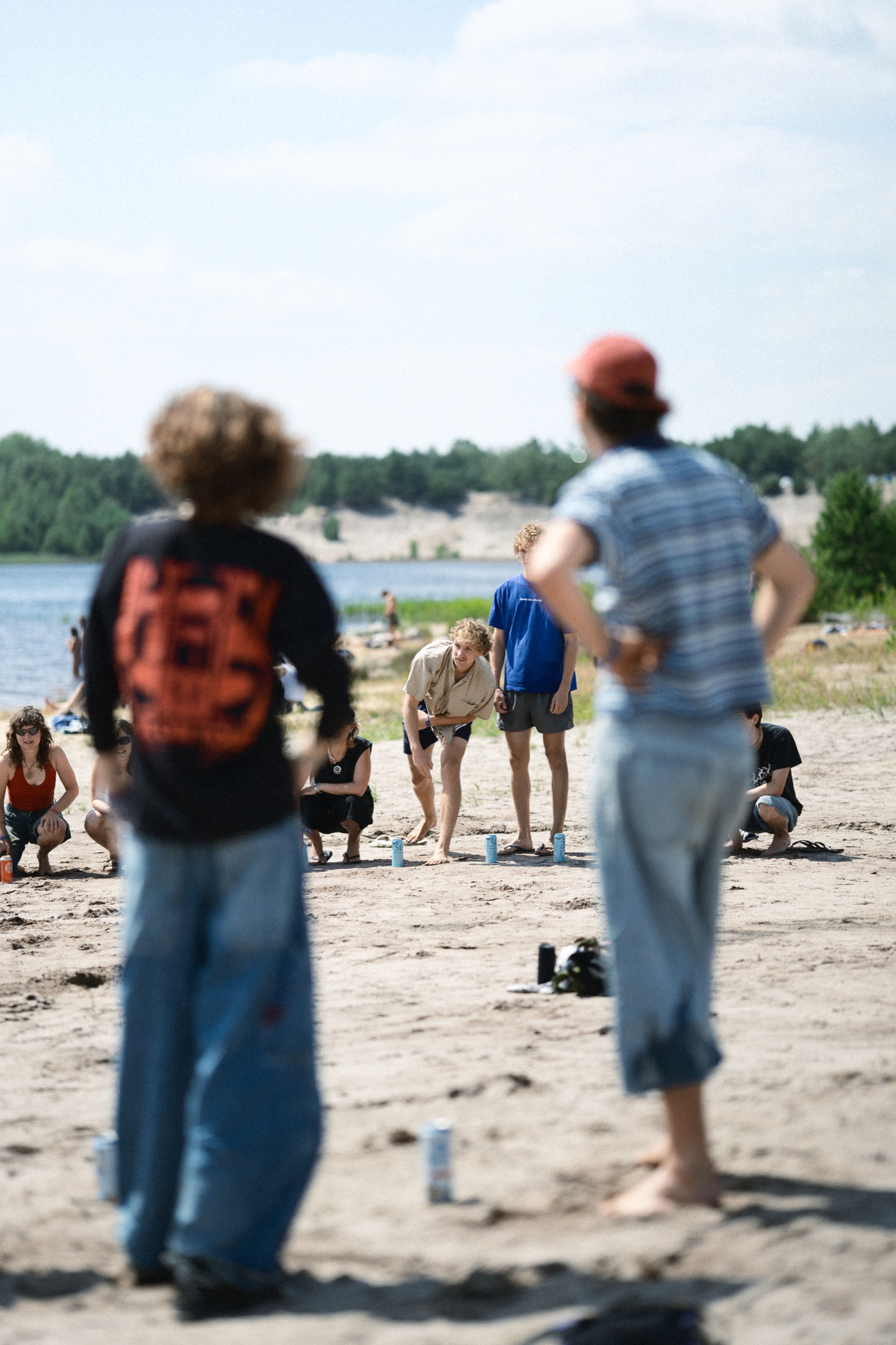 Friends playing beer pong on the lake beach