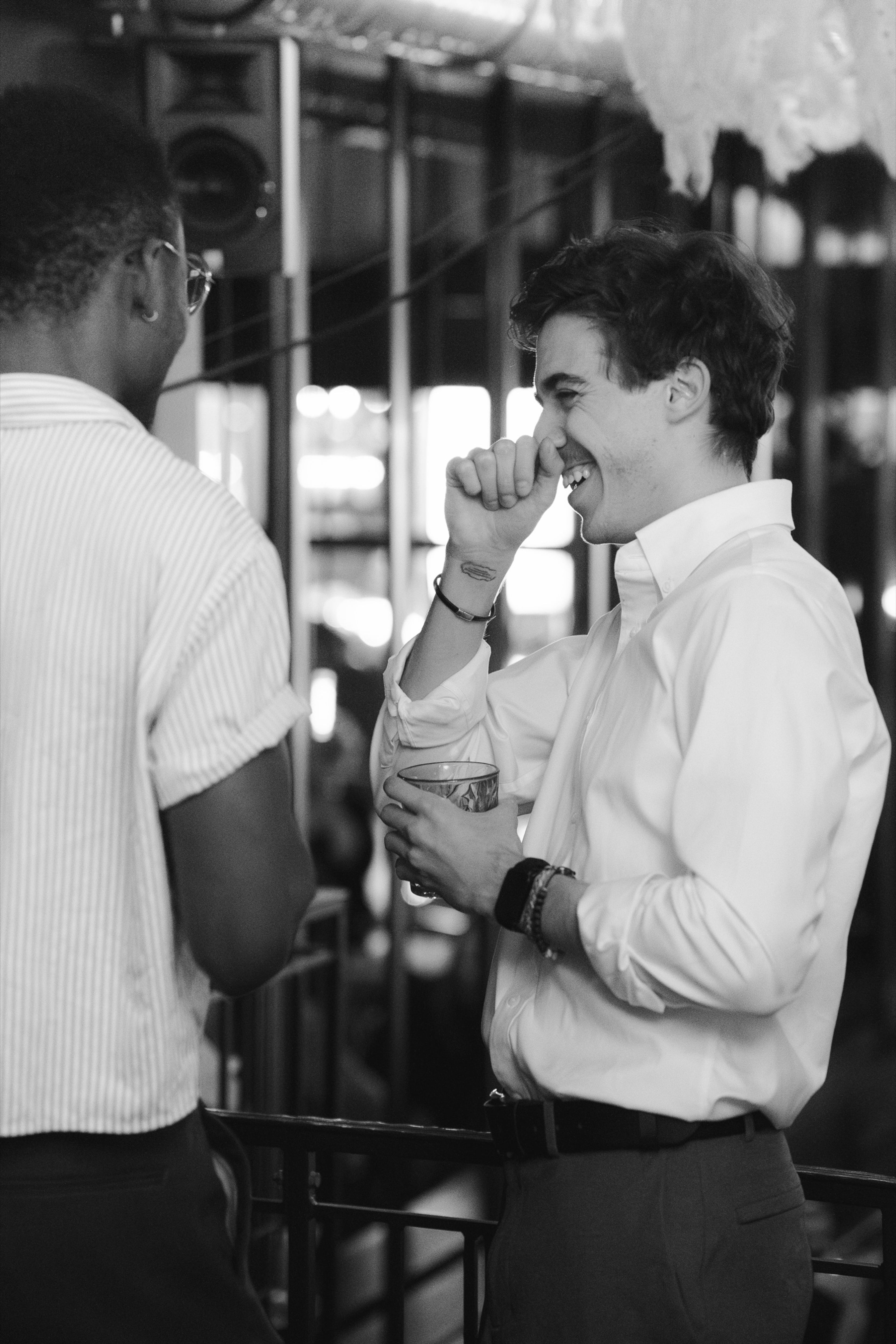 Two guests talking closely at the bar