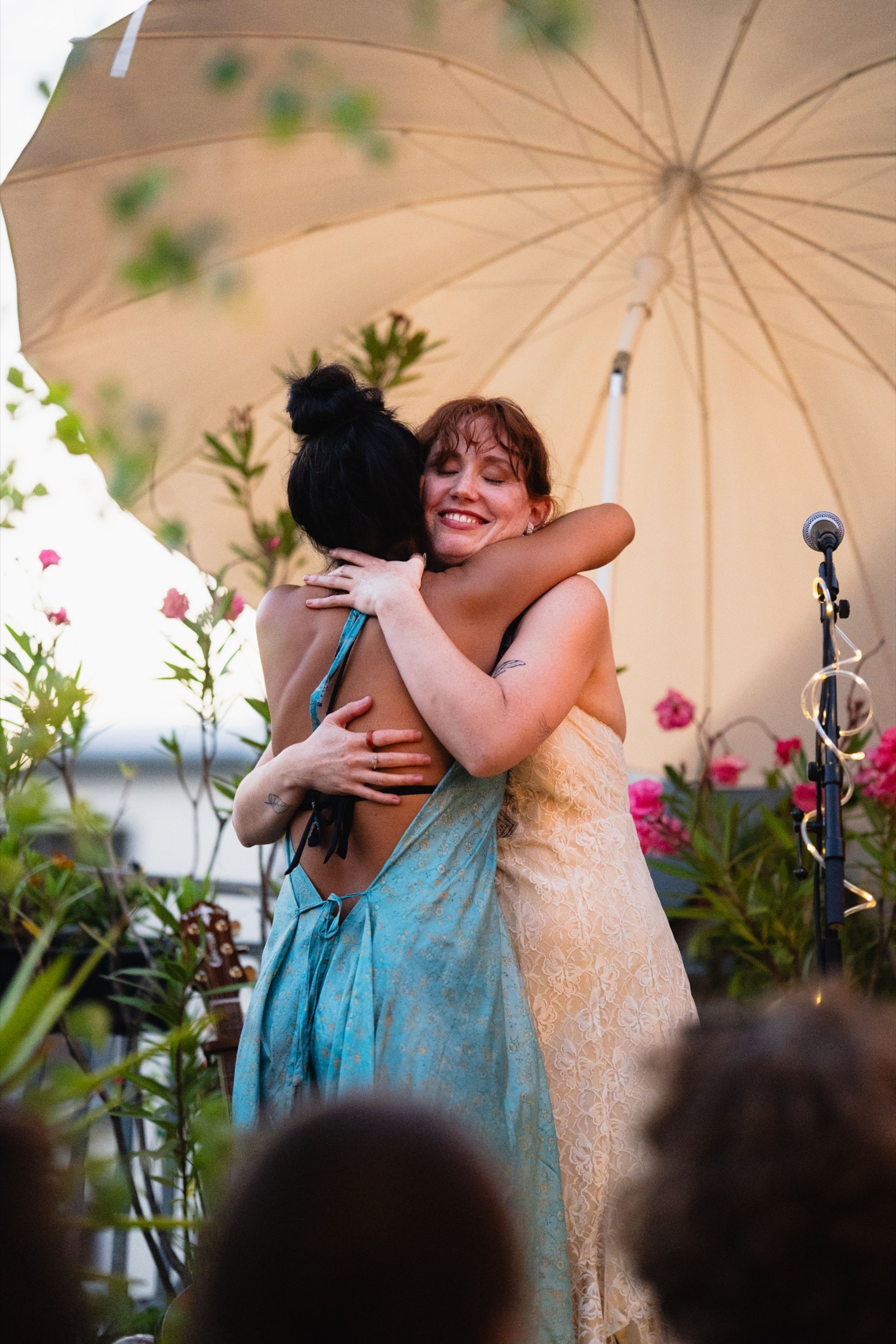 Two artists embracing on stage after their performance at Her Sound