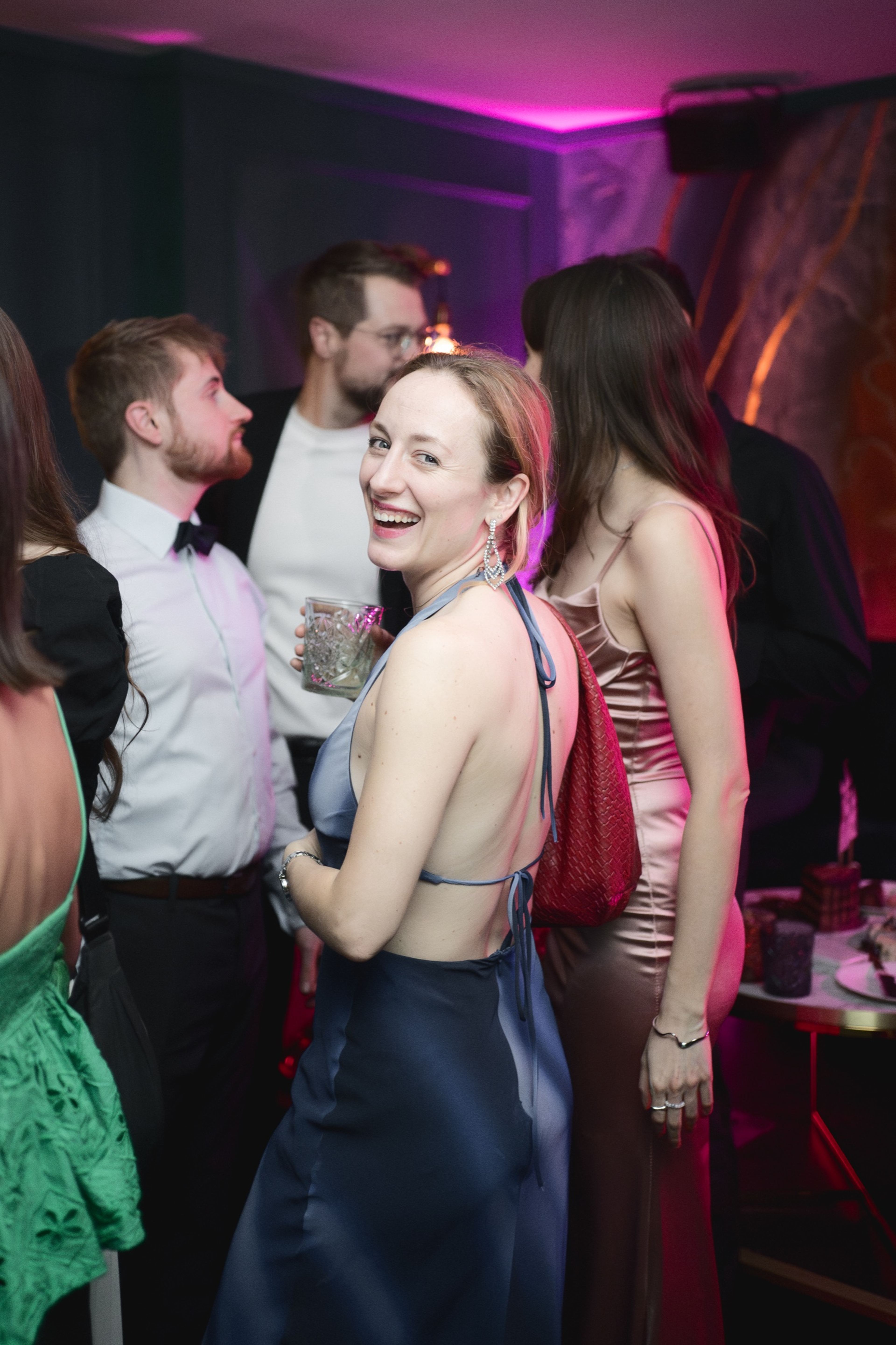 A guest dancing under the party lights