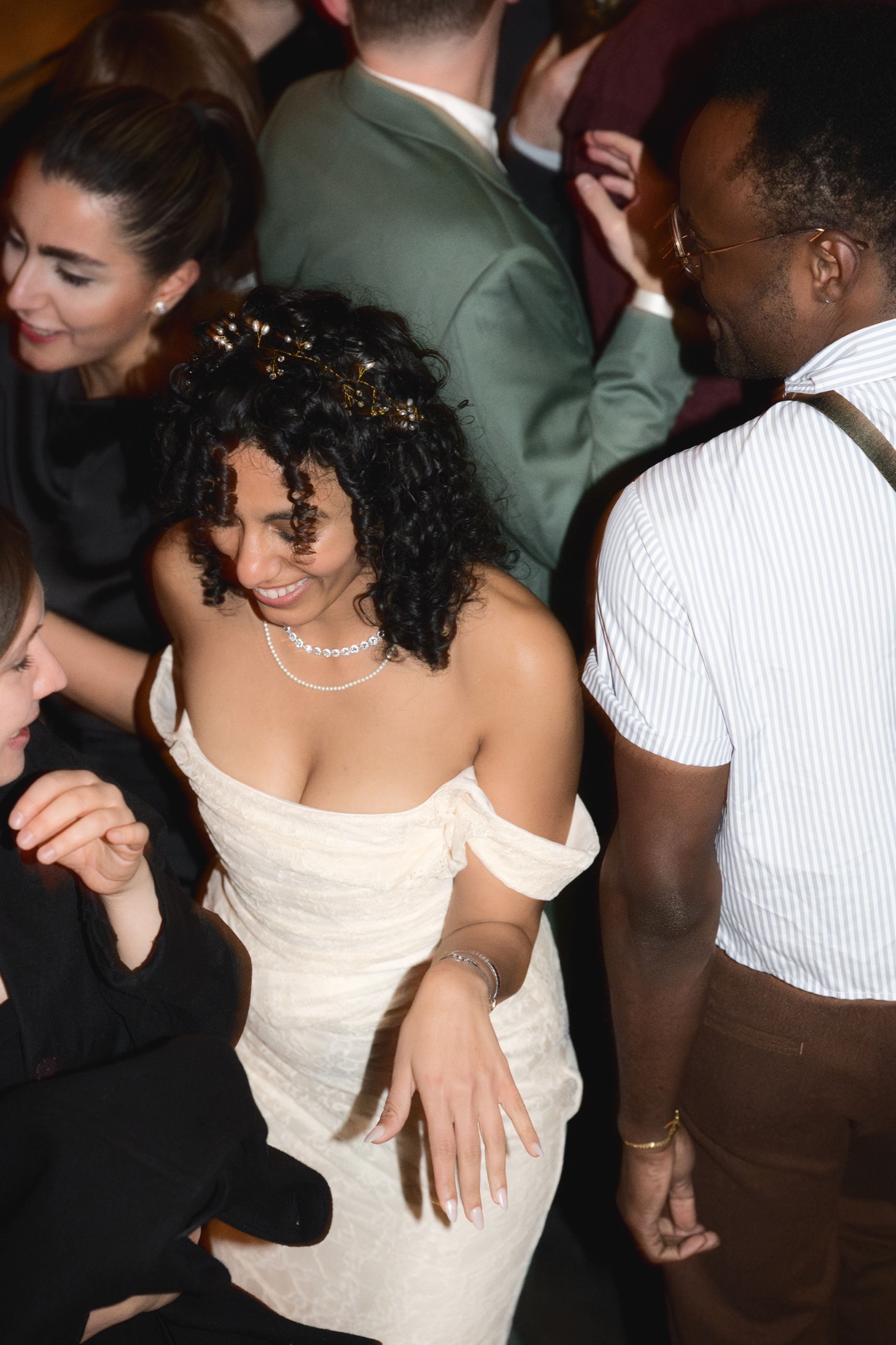 The bride dancing with guests at her wedding celebration