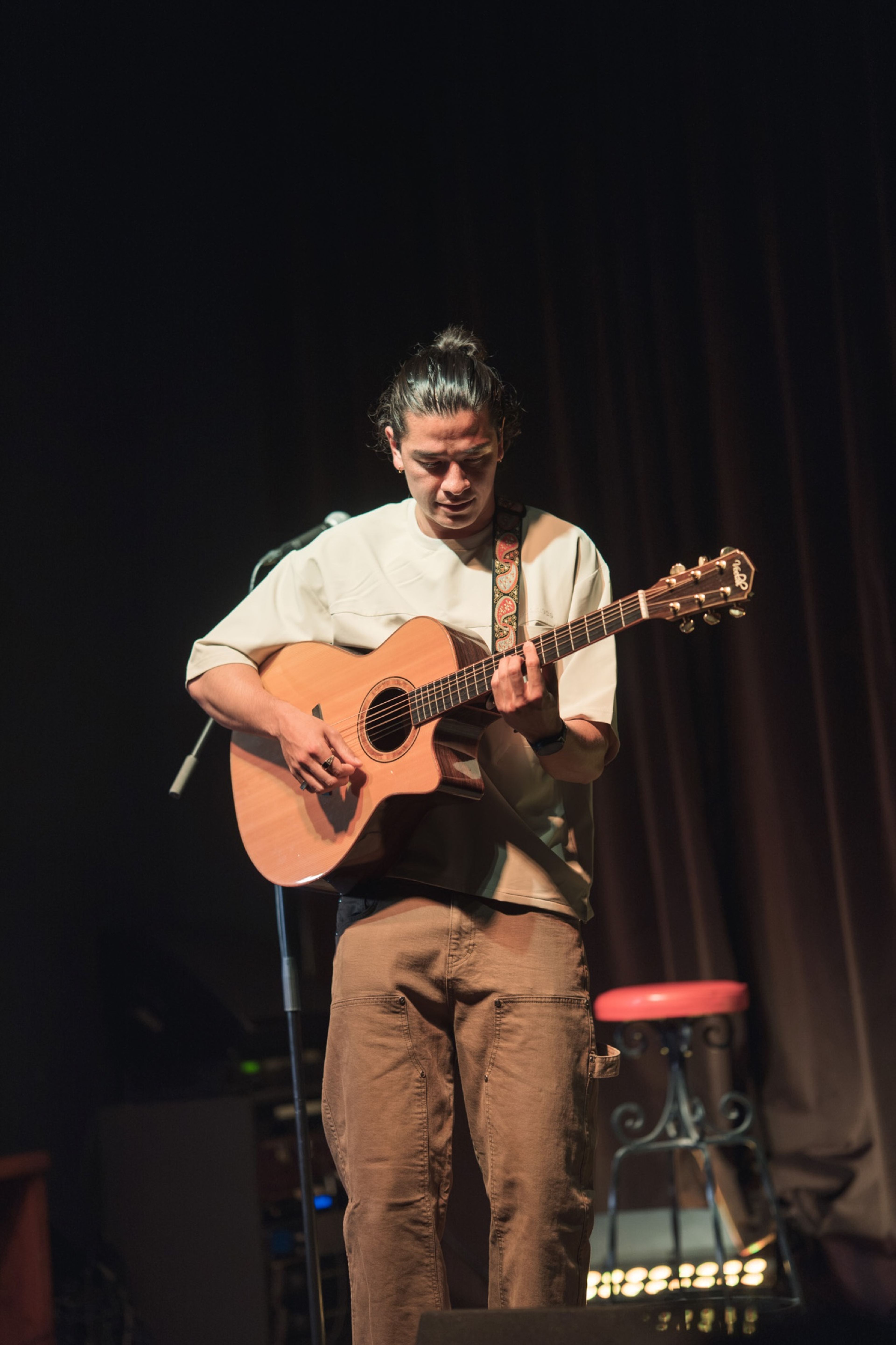 Musician performing with an acoustic guitar