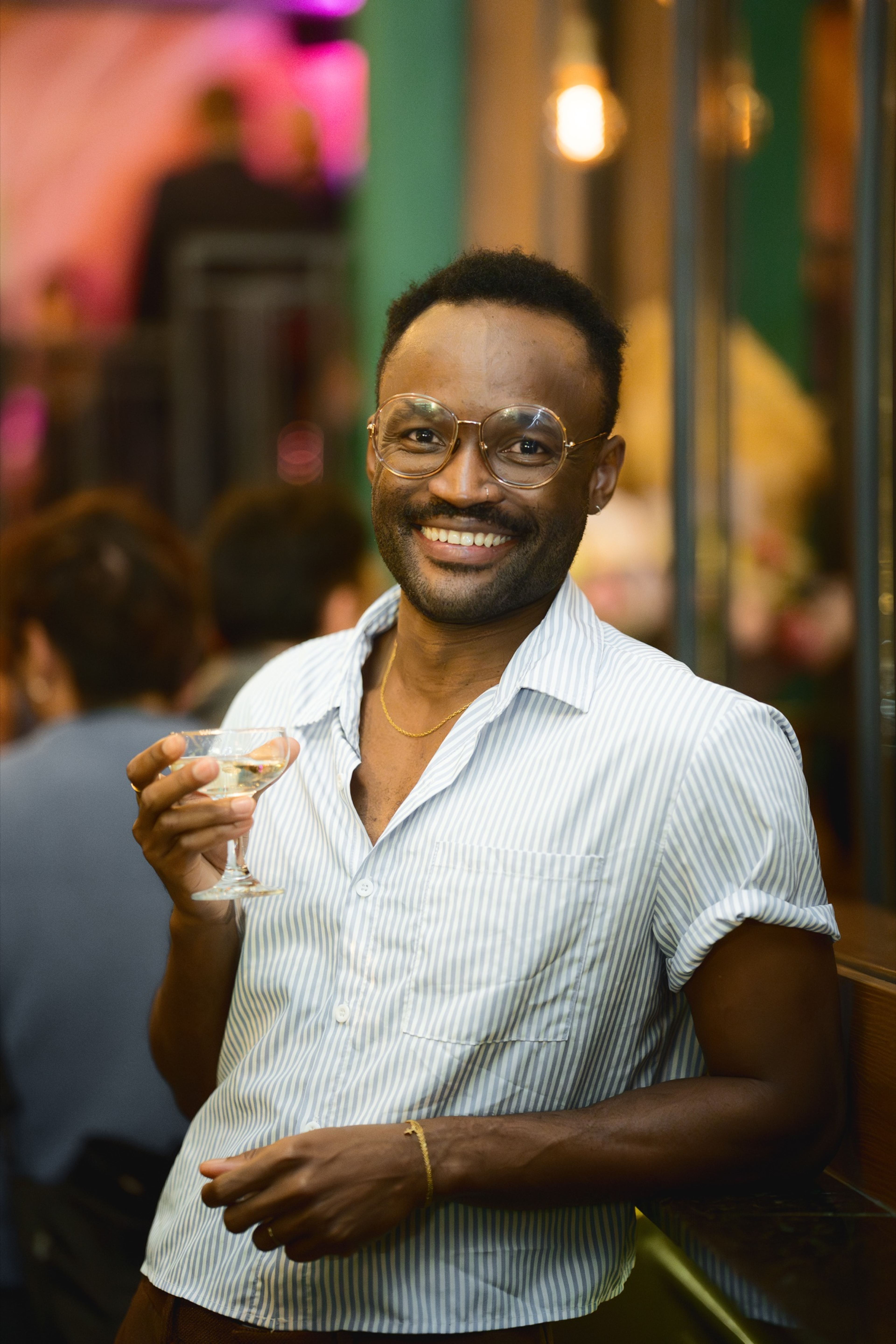 A guest laughing with a drink in hand