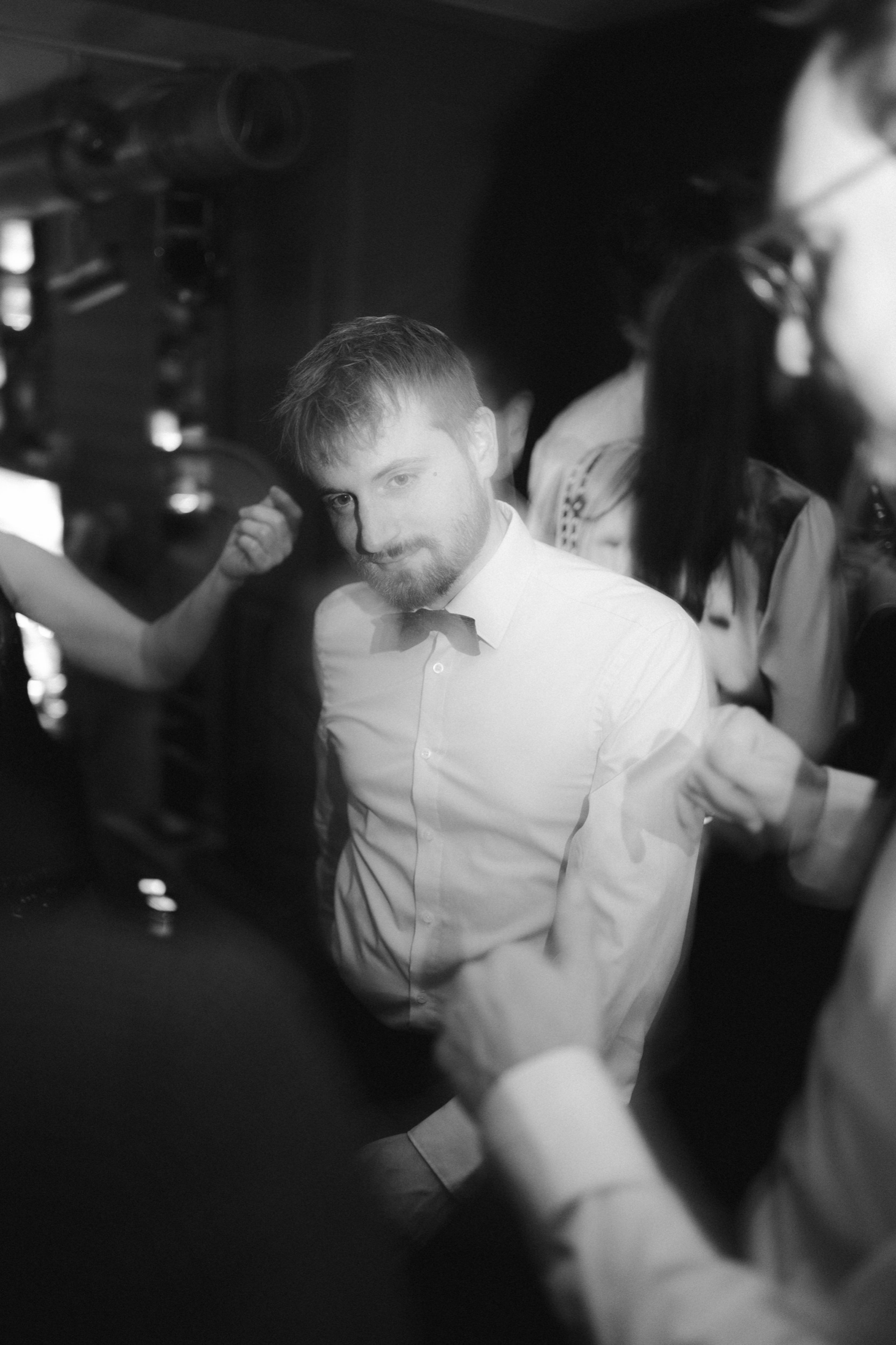 A guest dancing in a white shirt