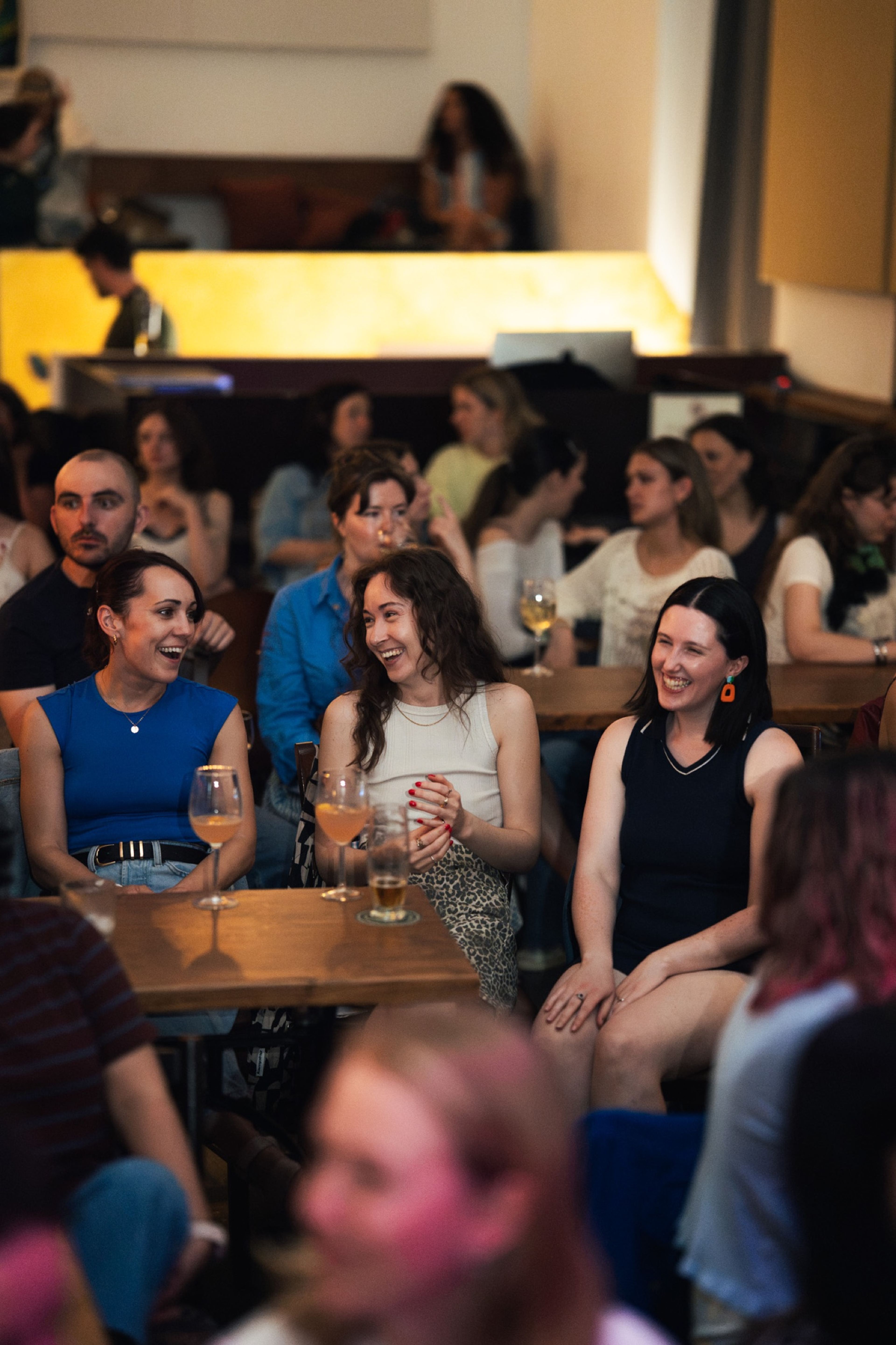 Friends laughing together in the audience