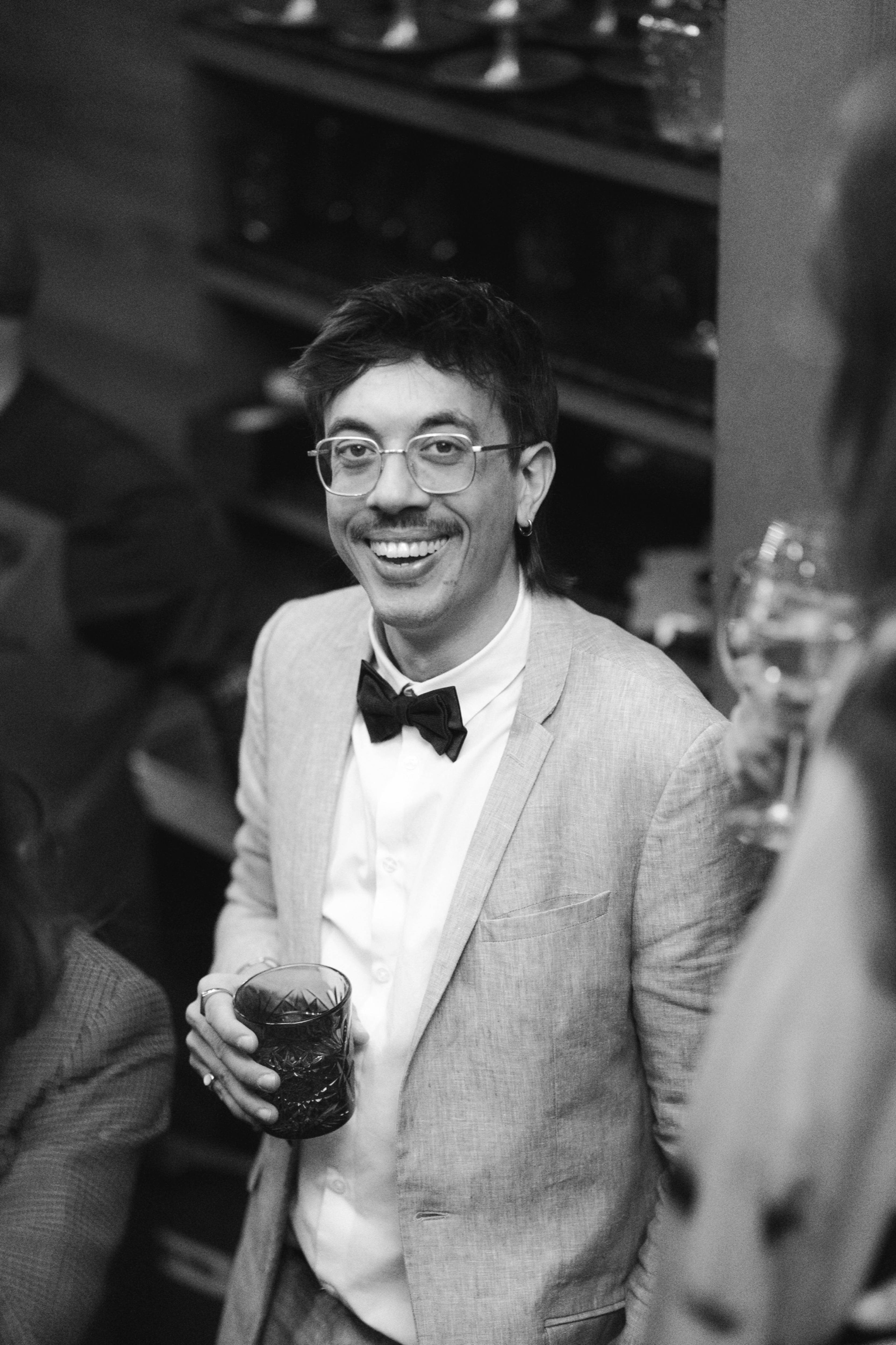 A guest in a bow tie smiling during the celebration