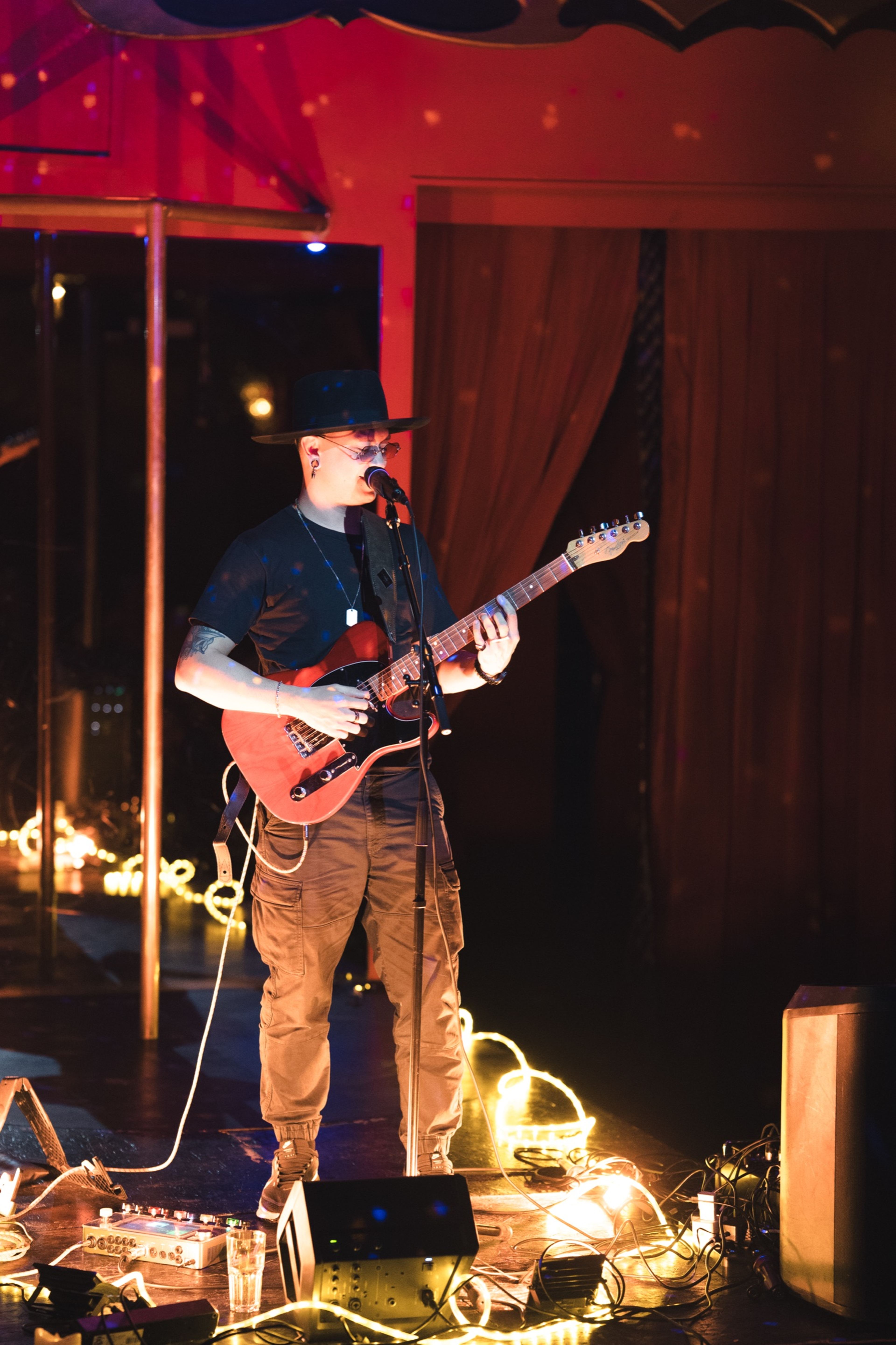 Guitarist performing on the intimate candle-lit stage