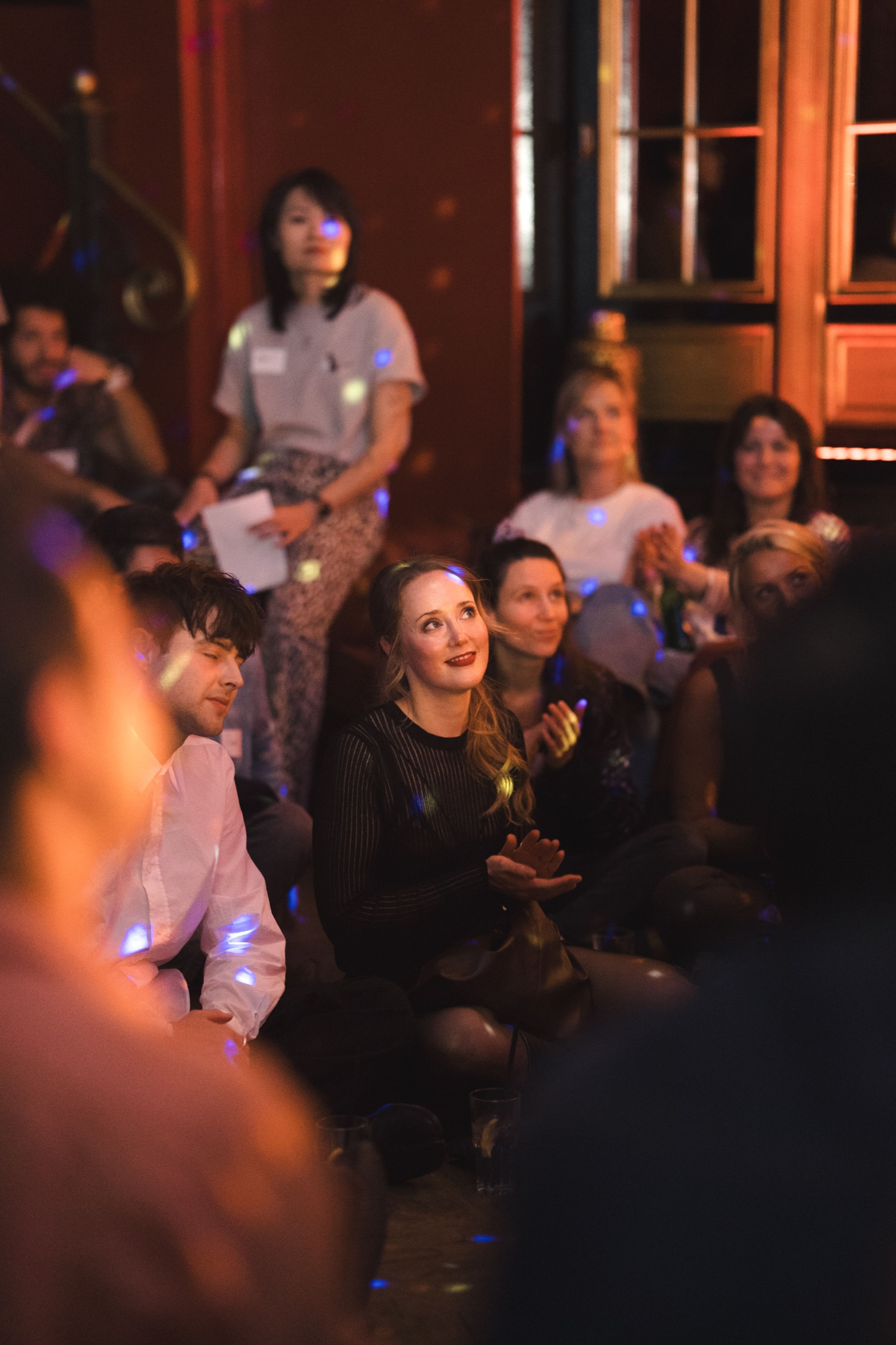 Audience seated close to the stage, watching intently