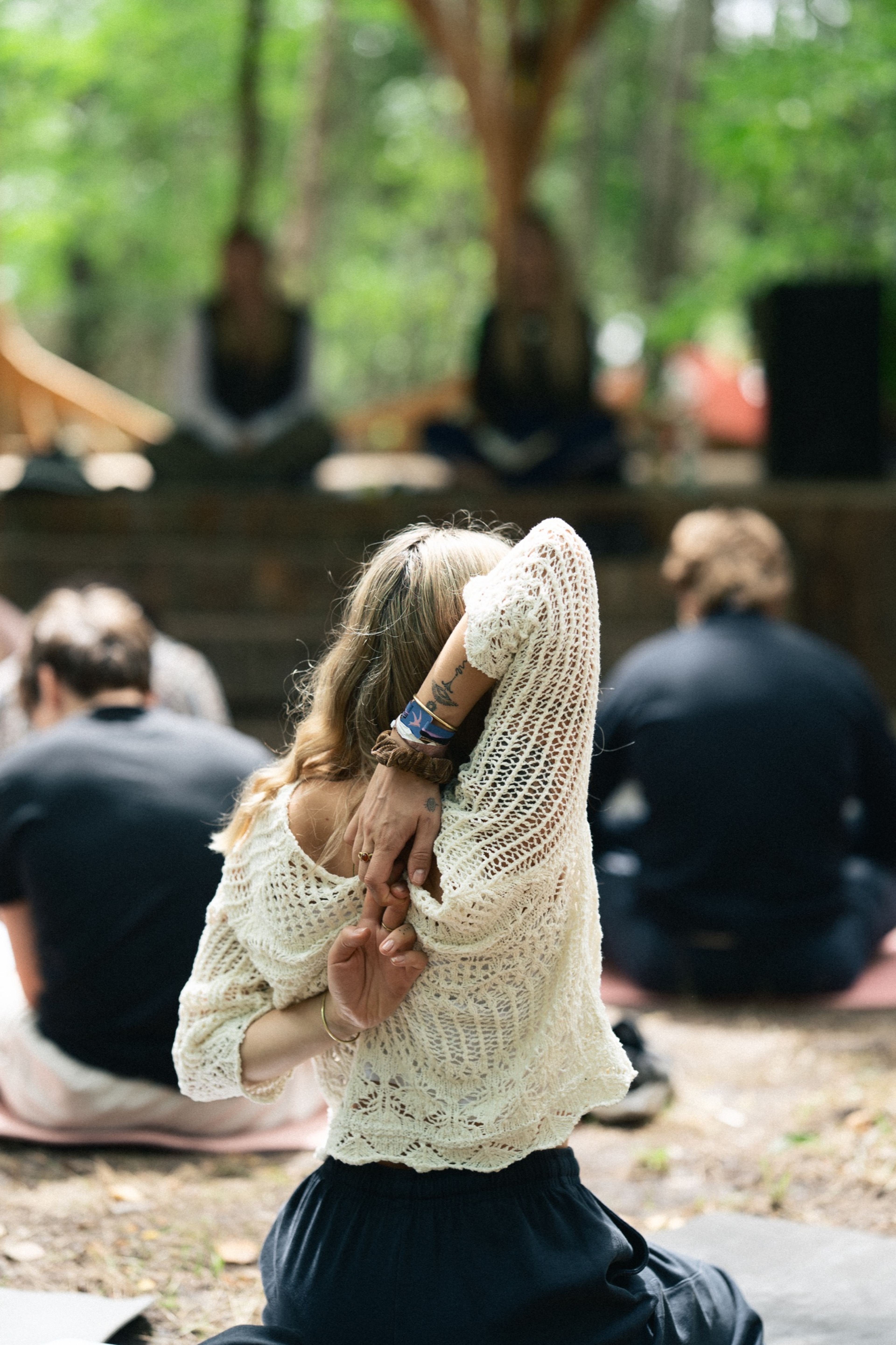 A woman stretching during an outdoor yoga session