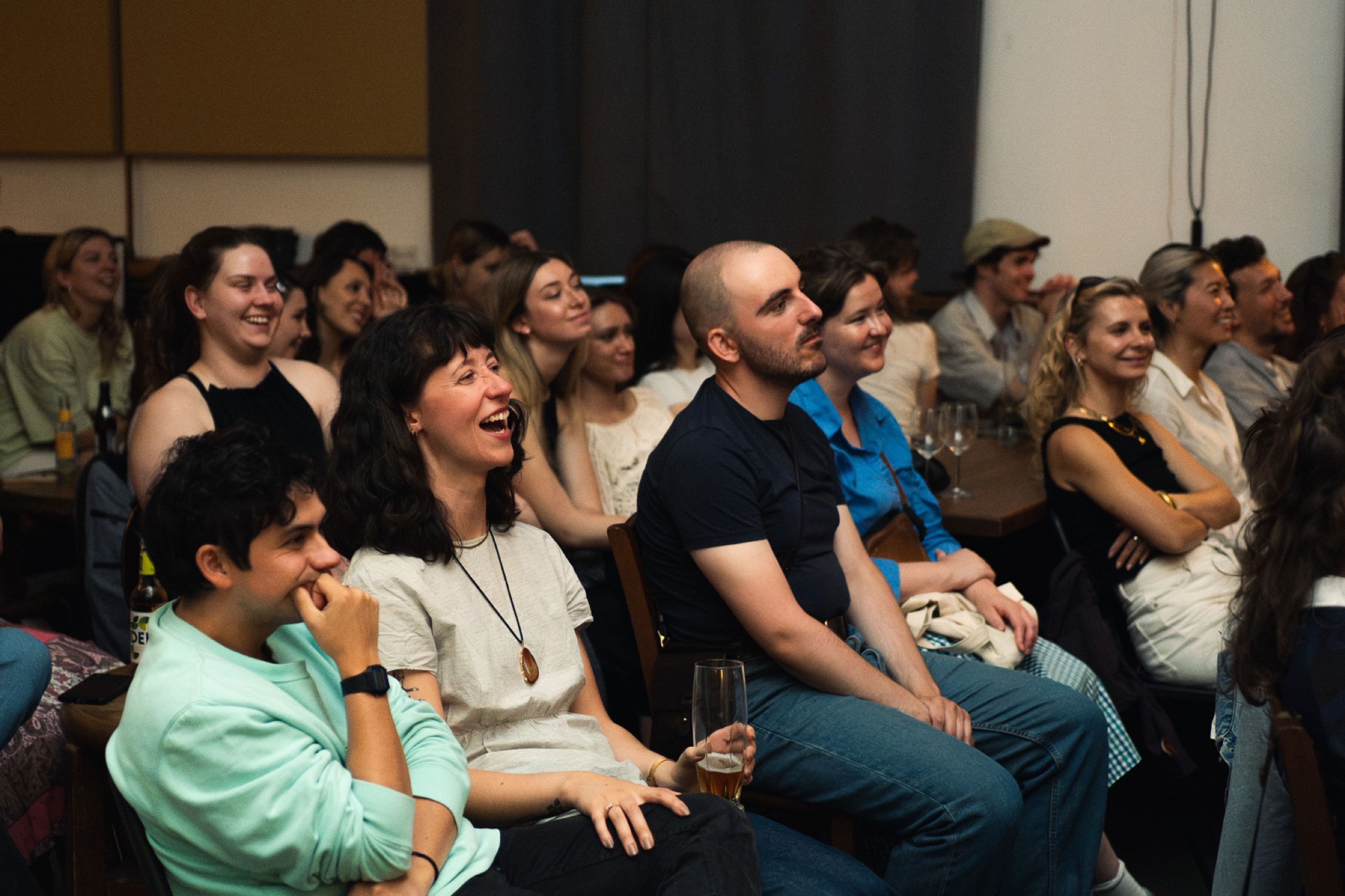 The audience laughing during a story