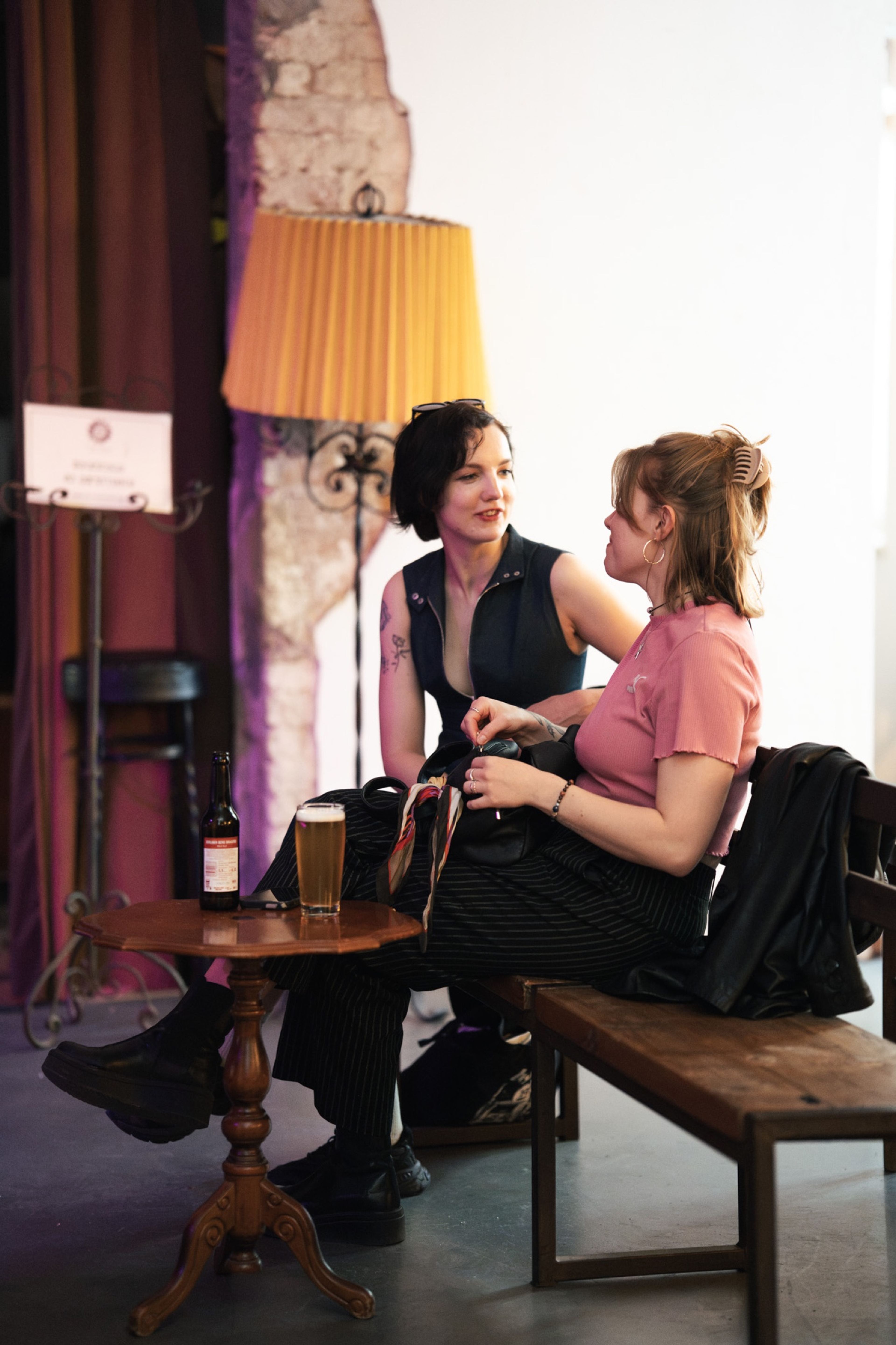 Two guests talking beside a lamp before the show