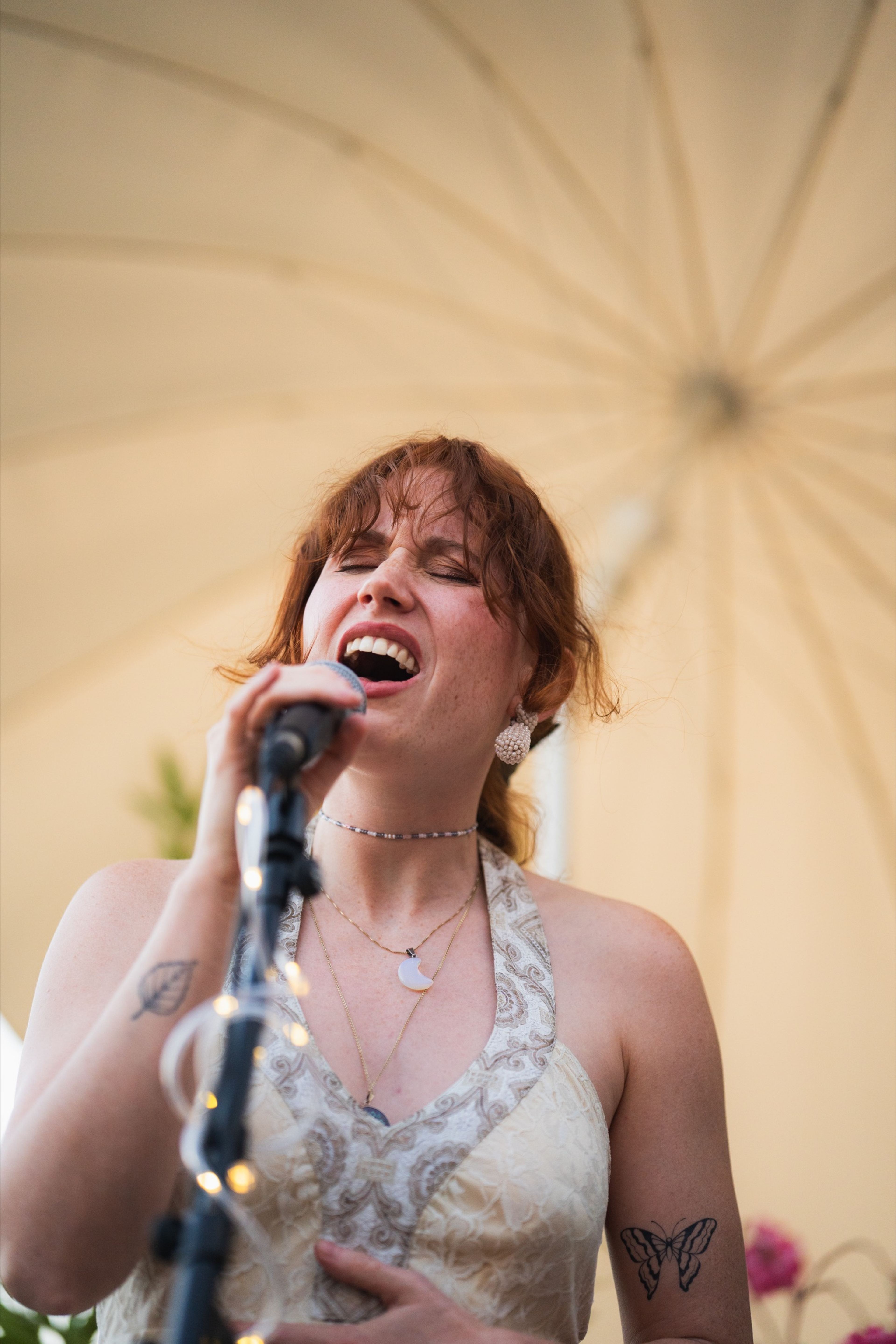 Red-haired vocalist singing passionately into the microphone
