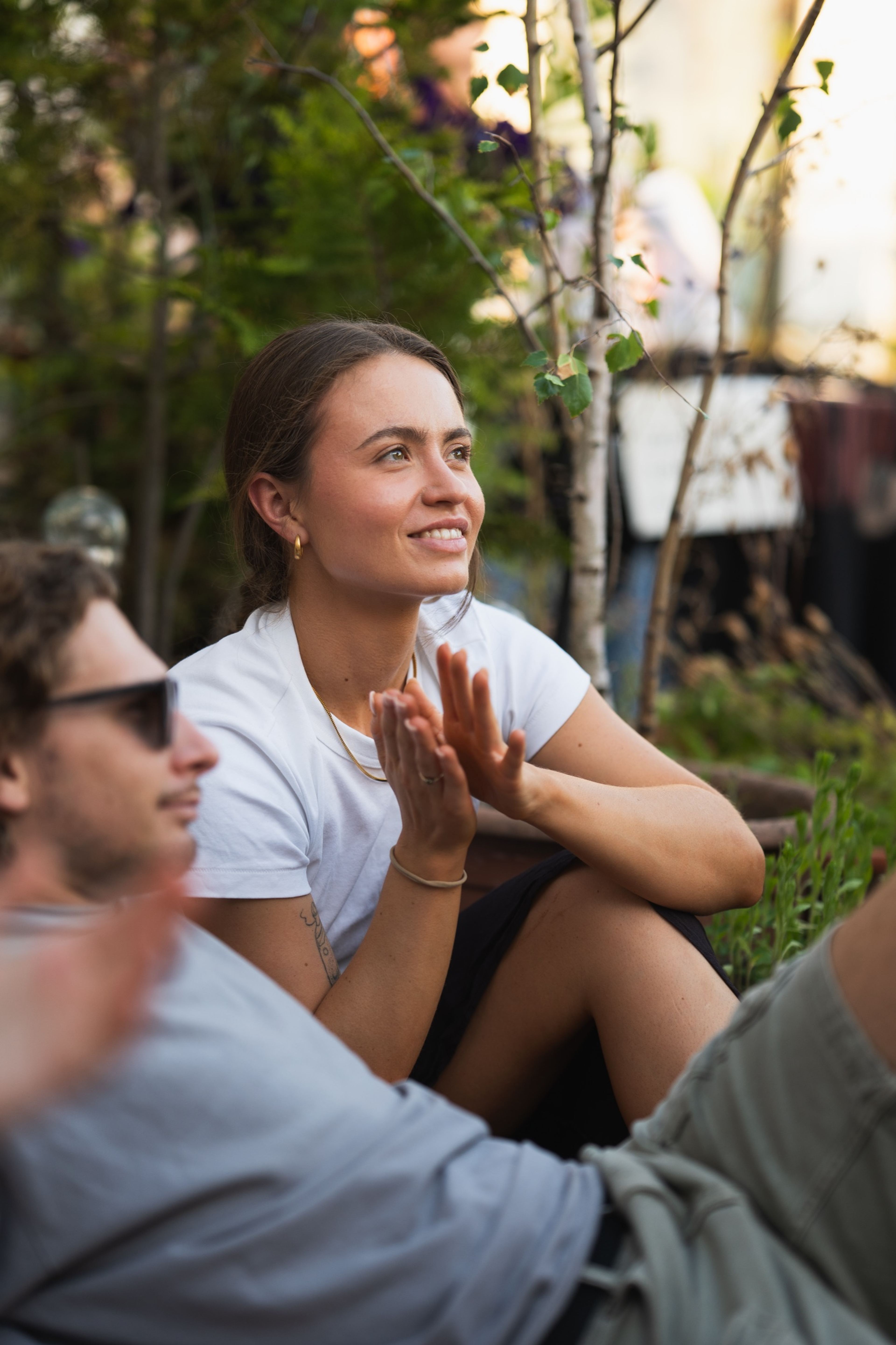 Audience member applauding in warm evening light