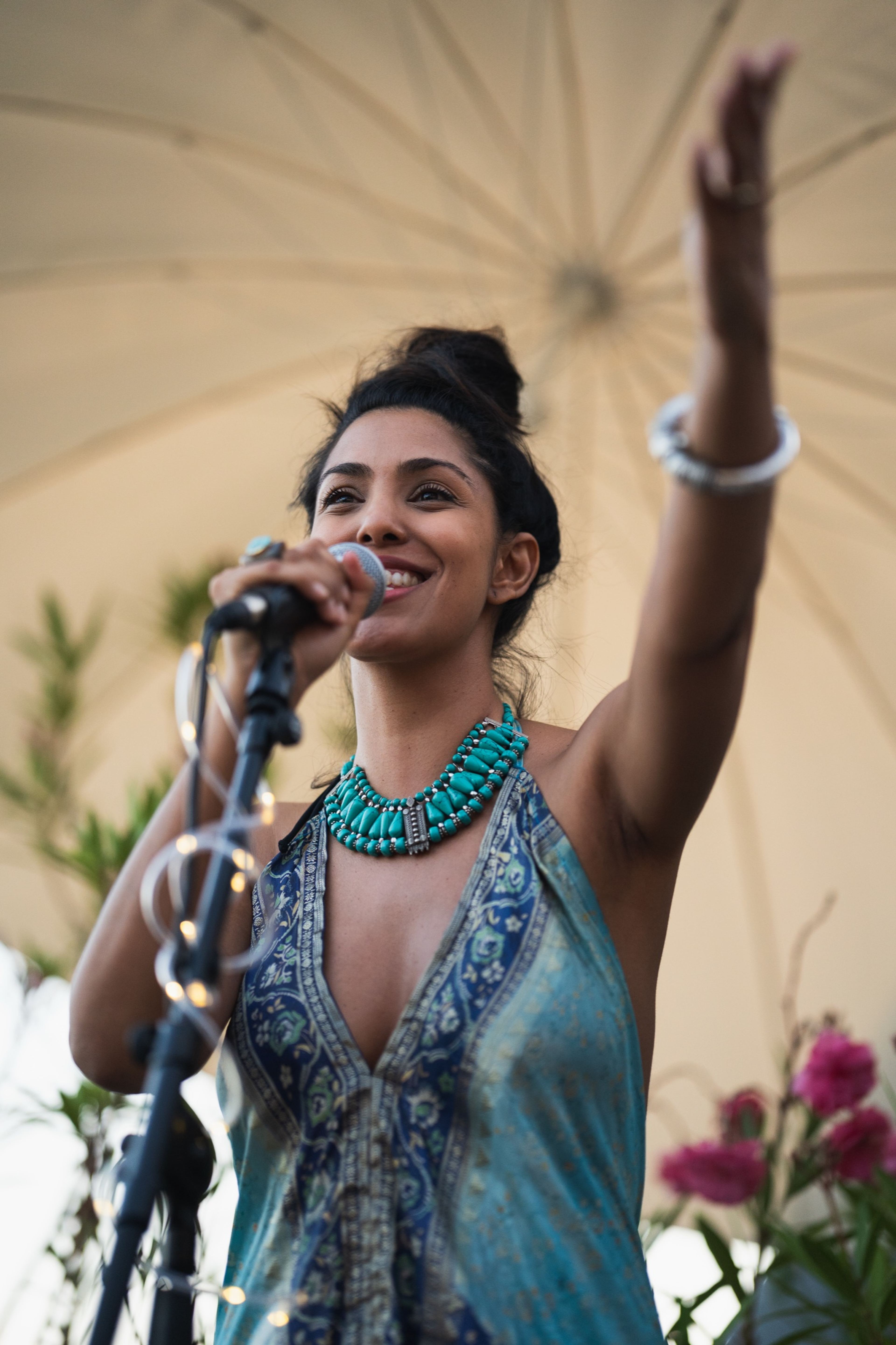 Singer raising her arm to the crowd during an energetic performance