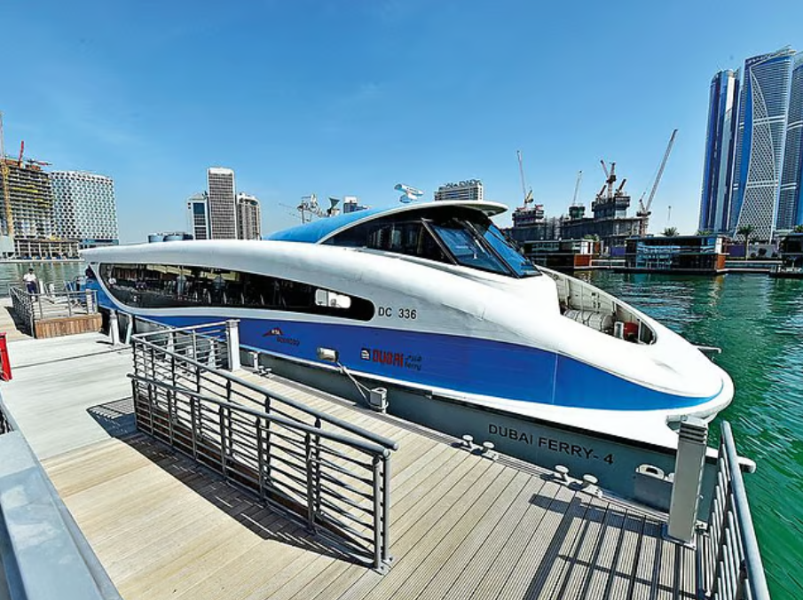 A blue and white Dubai Ferry moored at a wooden jetty