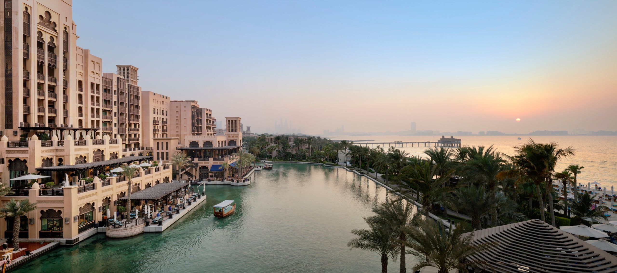 The waterways of Madinat Jumeirah at golden hour, seen from an Ocean Terrace Suite at Jumeirah Mina A'Salam