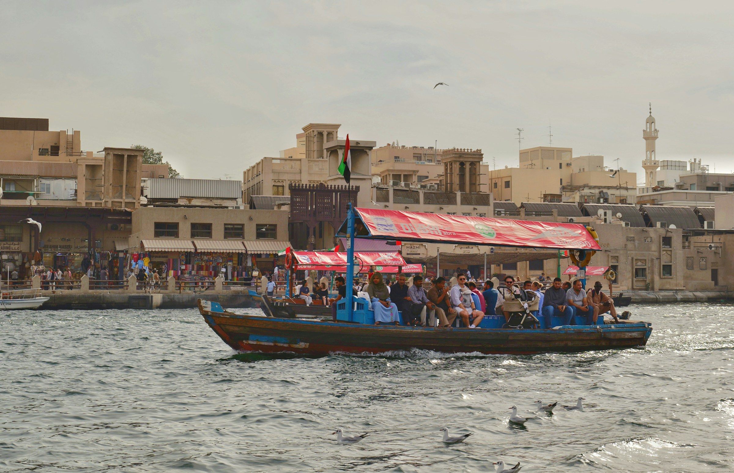 An abra crossing Dubai Creek in front of the old souks