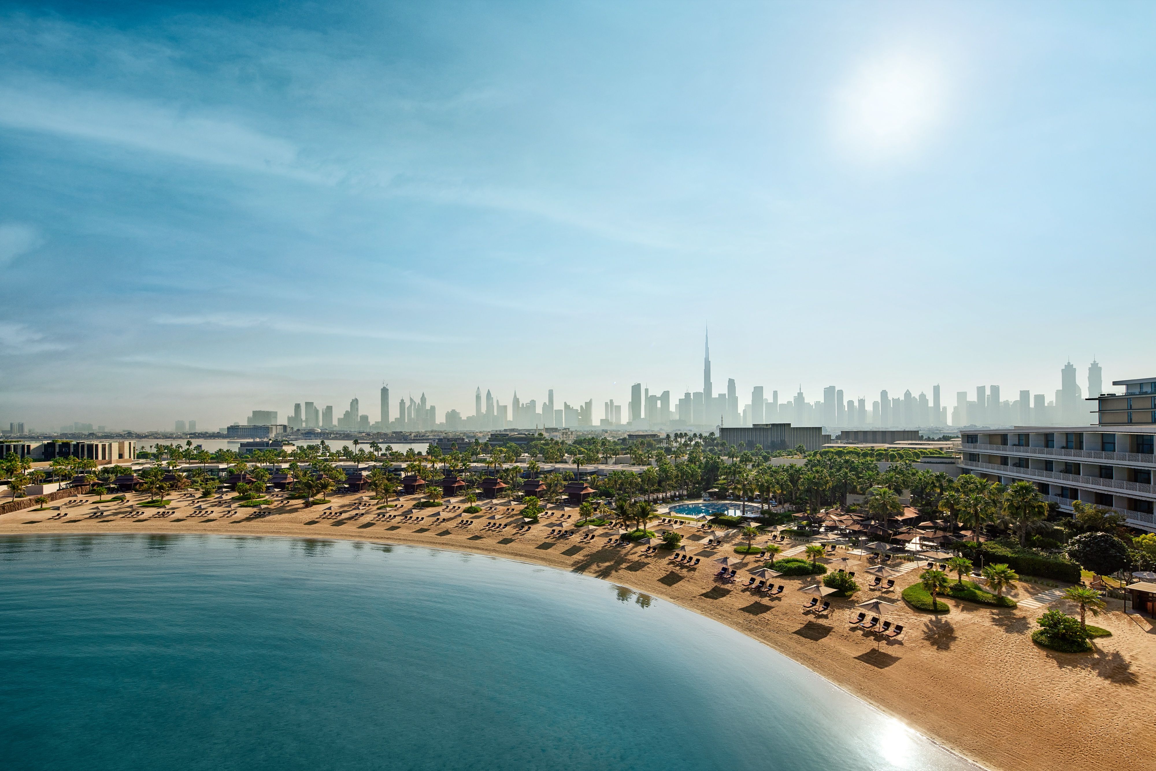 Bvlgari Resort Dubai's beach with the Dubai skyline beyond